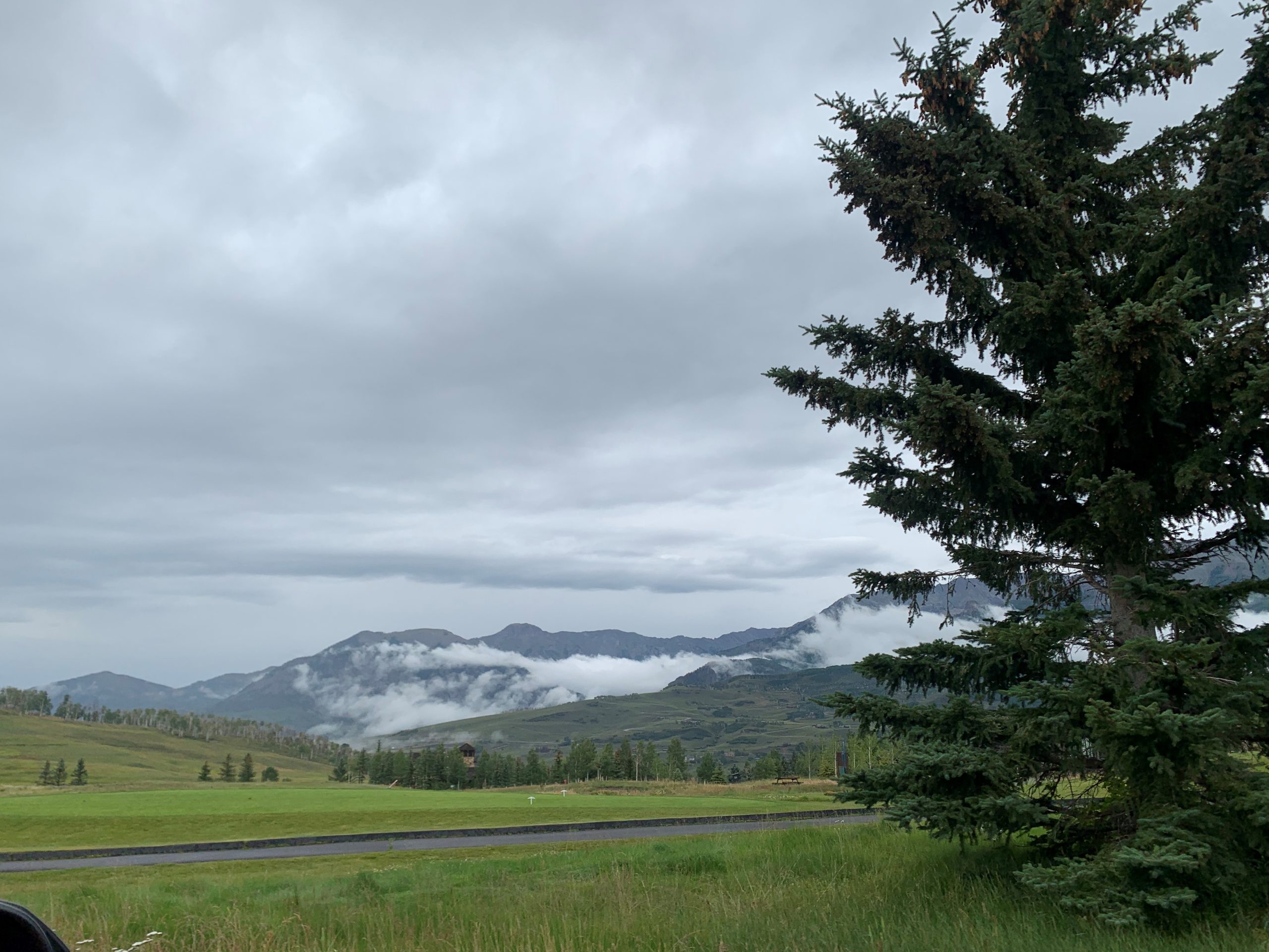 A photo of mountains and a road in Telluride, Colorado on a cloudy day.